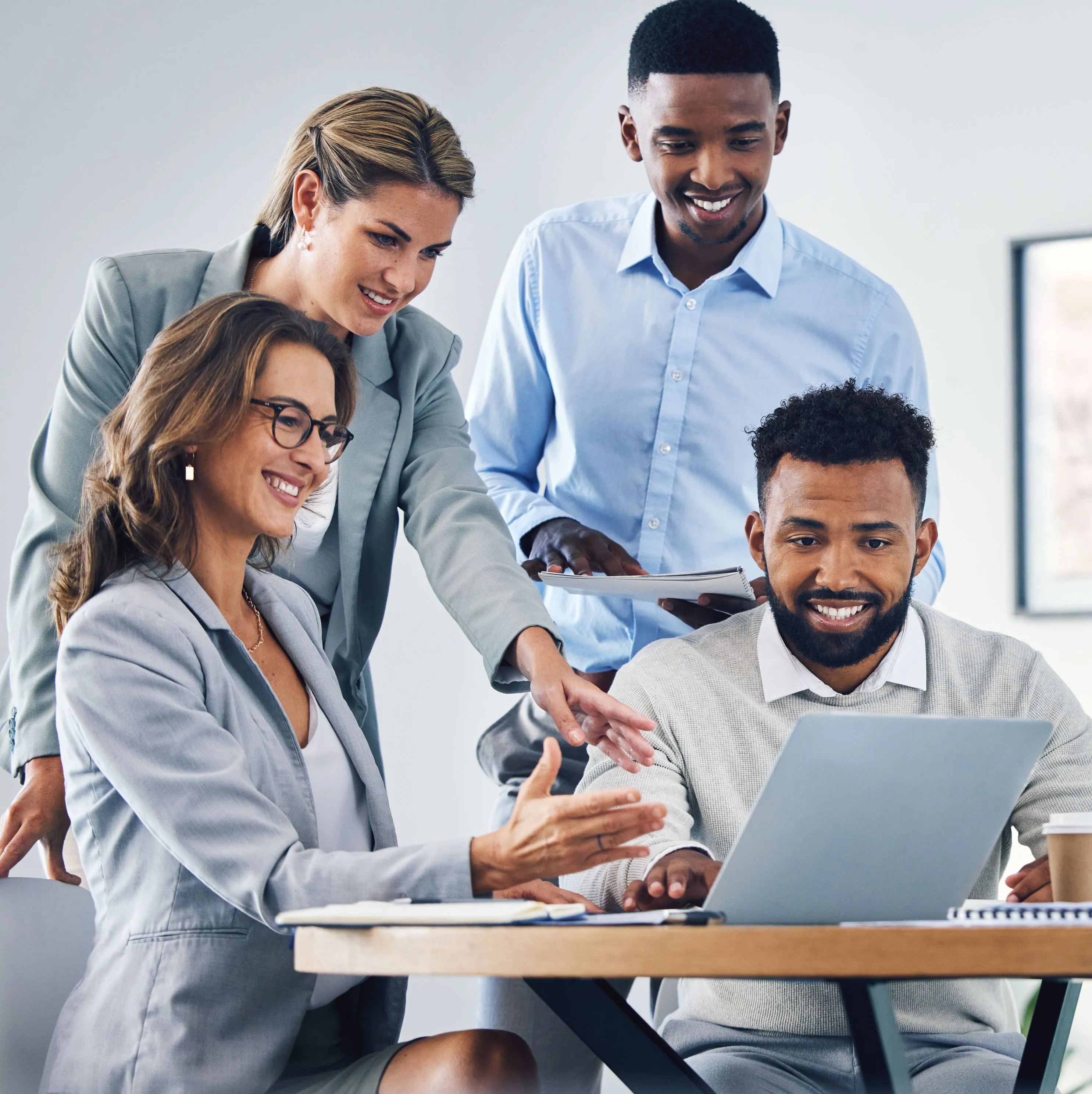 Young professionals collaborating around a laptop